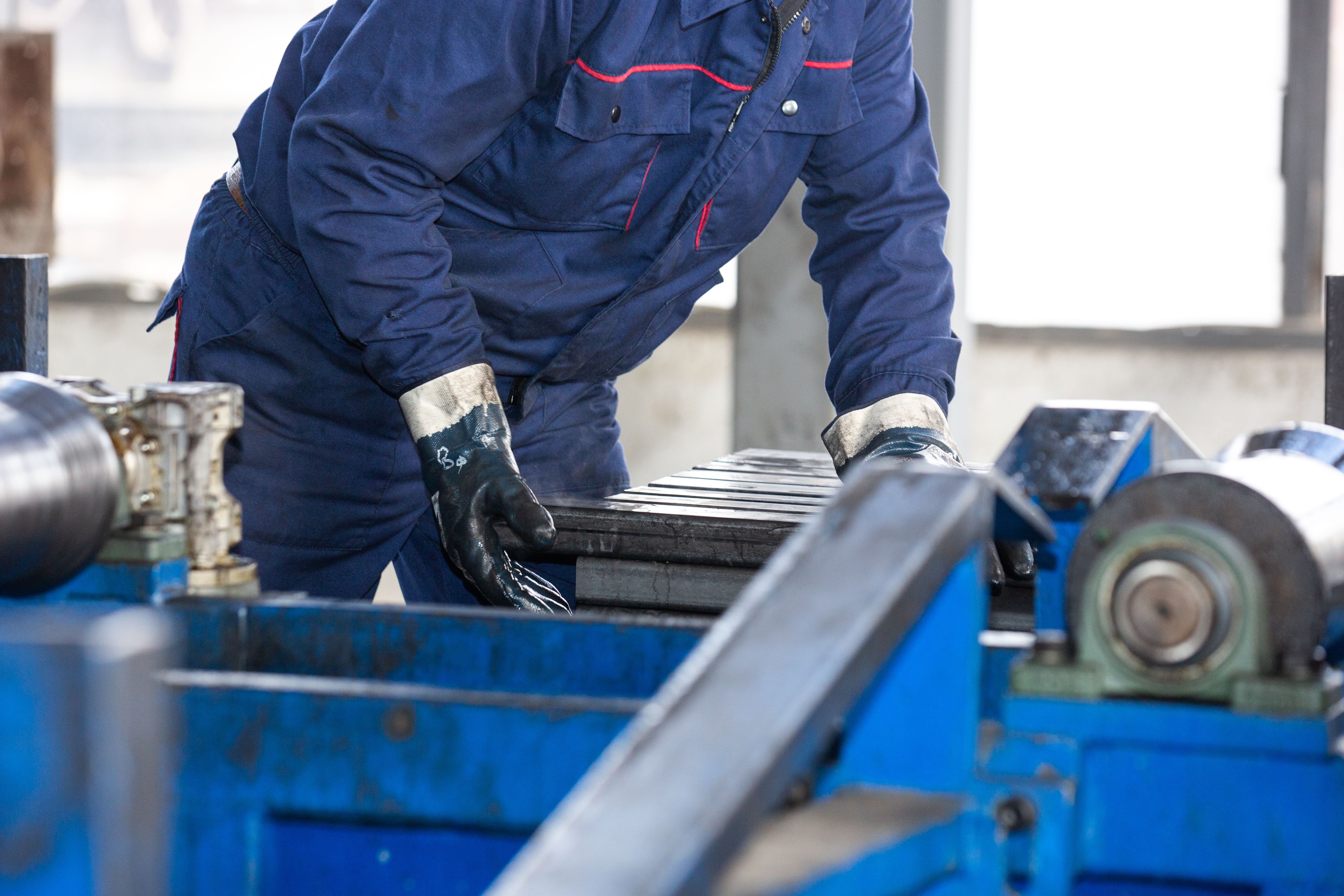 Manufacturing worker handing metal