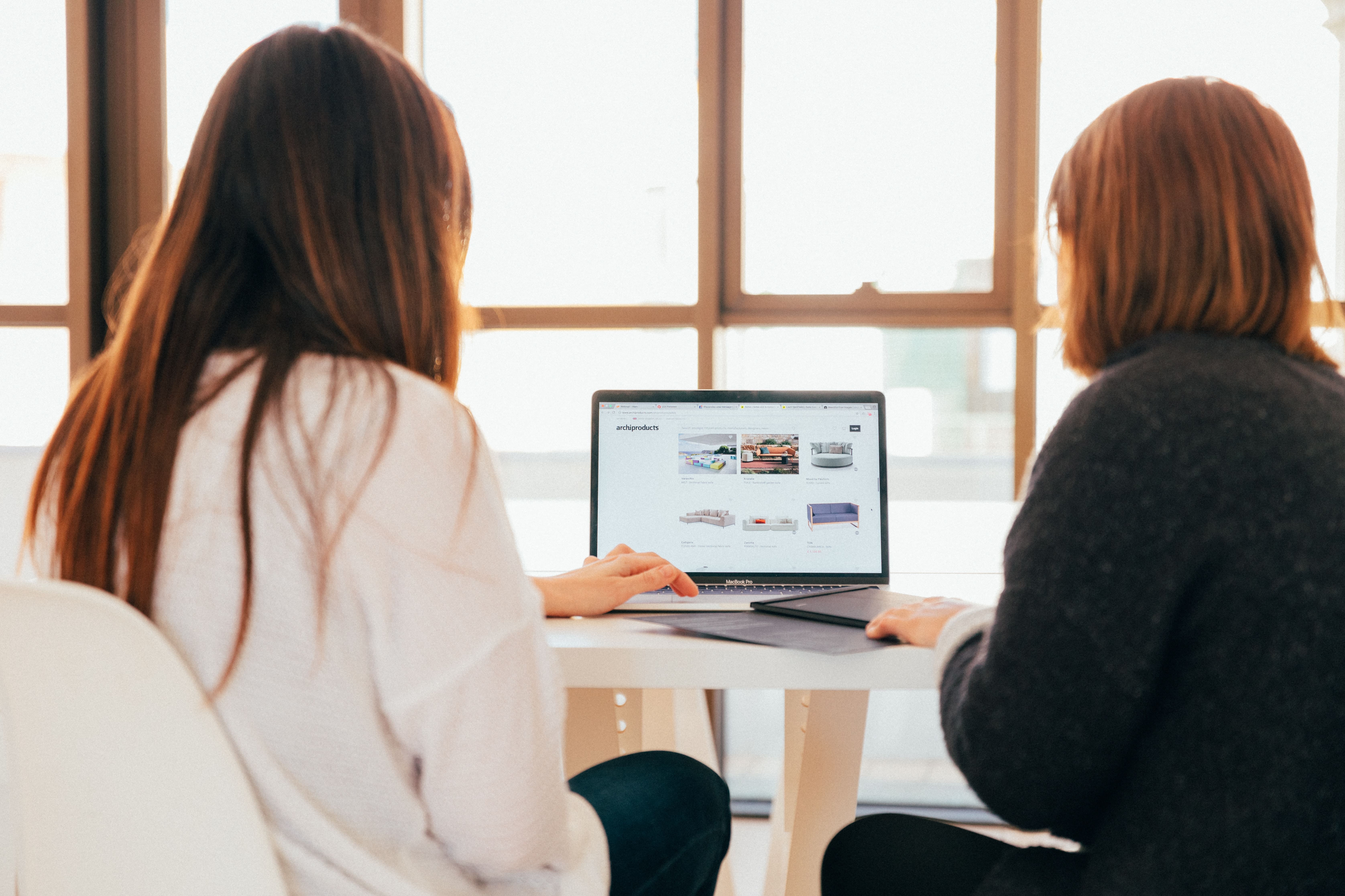 Two women completing their purchasing tasks